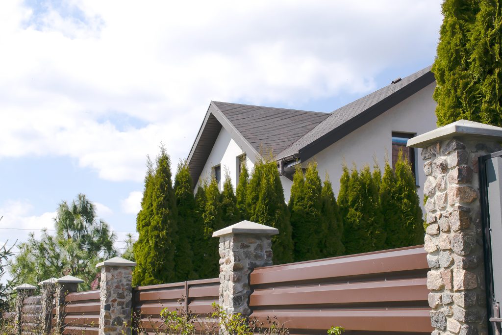 mixed materials fencing around home, showcasing choosing the right fence for your home 
