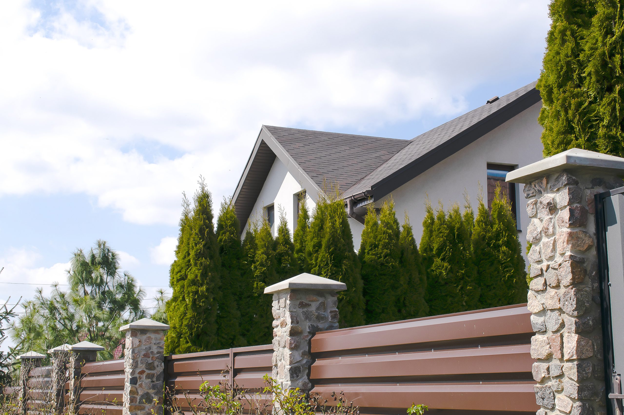 mixed materials fencing around home, showcasing choosing the right fence for your home 